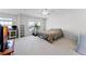 This bedroom has neutral carpet, a treadmill, and a comfortable bed at 2564 Bullion Loop, Sanford, FL 32771