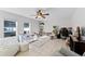 A well-lit bedroom featuring a ceiling fan, windows, a play area and desk space at 2564 Bullion Loop, Sanford, FL 32771
