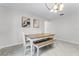 This dining room features a table with chairs and bench seating, accompanied by art pieces and a decorative chandelier at 2564 Bullion Loop, Sanford, FL 32771