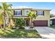 Charming two-story home with lush landscaping, beautiful palms, and a two car garage at 2564 Bullion Loop, Sanford, FL 32771