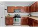 A modern kitchen boasting stainless steel appliances, abundant dark cabinetry, and neutral countertops at 2564 Bullion Loop, Sanford, FL 32771