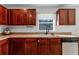 This kitchen features dark wood cabinets, stainless steel appliances, and granite countertops, creating a stylish and functional space at 2564 Bullion Loop, Sanford, FL 32771
