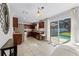 A contemporary kitchen with dark wood cabinets, stainless steel appliances, and a view of the pool through sliding glass doors at 2564 Bullion Loop, Sanford, FL 32771