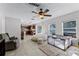 A casual living area with tile flooring, a large beanbag chair, and views into the kitchen and out to the patio at 2564 Bullion Loop, Sanford, FL 32771