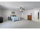 Spacious main bedroom featuring plush carpet, ceiling fan, and walk-in closet access at 2564 Bullion Loop, Sanford, FL 32771