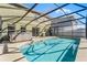 View of the pool and patio with a hot tub in a screened in enclosure at 2564 Bullion Loop, Sanford, FL 32771