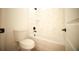 Clean bathroom featuring a toilet, and a shower-tub combination with marble tile surround at 2629 Sw 163Rd Pl, Ocala, FL 34473