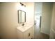 Bathroom featuring a modern vanity with black hardware, bright lighting, and wood-look flooring at 2629 Sw 163Rd Pl, Ocala, FL 34473