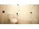 Clean bathroom featuring a toilet, and a shower-tub combination with marble tile surround at 2629 Sw 163Rd Pl, Ocala, FL 34473