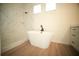 Bright bathroom featuring a freestanding tub, marble tiled shower, and wood-look flooring at 2629 Sw 163Rd Pl, Ocala, FL 34473