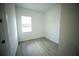 Bright bedroom features a window and light wood-look flooring at 2629 Sw 163Rd Pl, Ocala, FL 34473