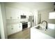 Bright modern kitchen with white cabinets, stainless steel appliances, and an open layout at 2629 Sw 163Rd Pl, Ocala, FL 34473