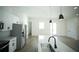 A bright open concept kitchen features stainless steel appliances, white cabinets, and views of the living area at 2629 Sw 163Rd Pl, Ocala, FL 34473
