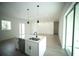 Open concept kitchen features white cabinets, stainless appliances and an island with seating adjacent to the living area at 2629 Sw 163Rd Pl, Ocala, FL 34473