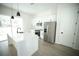 Modern kitchen boasts white cabinets, stainless steel appliances, and a center island with a black faucet at 2629 Sw 163Rd Pl, Ocala, FL 34473