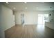 Open floor plan showcasing the kitchen island and living area with light wood flooring at 2629 Sw 163Rd Pl, Ocala, FL 34473