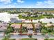 Aerial view showcasing a tile roof home community with backyard ponds and private docks at 3571 Somerset Cir, Kissimmee, FL 34746