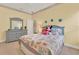 Bright bedroom with tiled floors, bed, and a dresser at 3571 Somerset Cir, Kissimmee, FL 34746