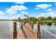 Picturesque lake view from the dock with lush greenery, perfect for waterfront enjoyment and scenic relaxation at 3571 Somerset Cir, Kissimmee, FL 34746