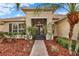 Close-up of the front door and entry way framed by well maintained plants and mulch at 3571 Somerset Cir, Kissimmee, FL 34746