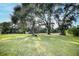 Expansive backyard with sprawling green lawn and mature shade trees creating a serene outdoor space at 4178 S Chickasaw Trl, Orlando, FL 32829