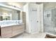 Modern bathroom with sleek vanity, stylish mirror, and a glass-enclosed shower with marble tiling at 4178 S Chickasaw Trl, Orlando, FL 32829