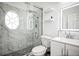 Elegant bathroom featuring a glass shower, modern fixtures, and white marble tiles at 4178 S Chickasaw Trl, Orlando, FL 32829