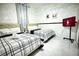 Cozy bedroom with two twin beds, stylish bedding, and a wall-mounted TV at 4178 S Chickasaw Trl, Orlando, FL 32829