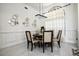 Bright dining room features modern light fixture and decorated wall with a stylish table set at 4178 S Chickasaw Trl, Orlando, FL 32829