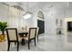 Bright dining area features a modern chandelier, tile flooring, and decorative window with sheer white curtains at 4178 S Chickasaw Trl, Orlando, FL 32829