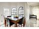 Bright dining area features tile flooring, a modern table with seating, and two arched windows at 4178 S Chickasaw Trl, Orlando, FL 32829