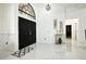 Grand entryway featuring double doors, soaring ceiling and an elegant foyer table with decorative accessories at 4178 S Chickasaw Trl, Orlando, FL 32829