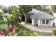 Attractive front exterior featuring a meticulously landscaped lawn, elegant columns, and a tiled roof at 4178 S Chickasaw Trl, Orlando, FL 32829