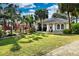 Beautiful single-story home boasting lush landscaping, palm trees, and vibrant red flowering plants at 4178 S Chickasaw Trl, Orlando, FL 32829