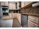 Kitchen area showcasing stainless steel appliances, granite countertops, and light wood cabinets at 4178 S Chickasaw Trl, Orlando, FL 32829