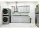 Contemporary laundry area with sleek appliances, stylish cabinetry, and a modern design at 4178 S Chickasaw Trl, Orlando, FL 32829