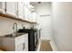 Functional laundry room equipped with modern appliances and ample storage cabinets at 4178 S Chickasaw Trl, Orlando, FL 32829