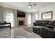 Bright living room features modern tile floors, a decorative fireplace, and a leather sofa at 4178 S Chickasaw Trl, Orlando, FL 32829