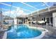 A large in-ground pool surrounded by pavers in screened in enclosure at 4178 S Chickasaw Trl, Orlando, FL 32829