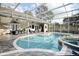 A spacious screened-in pool area with a pool and spa at 4178 S Chickasaw Trl, Orlando, FL 32829