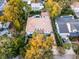 Aerial view of a home with a terracotta roof nestled among lush greenery in a residential neighborhood at 419 Raehn St, Orlando, FL 32806