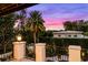 View from balcony featuring landscaped backyard with pool and colorful sunset at 419 Raehn St, Orlando, FL 32806