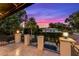 Balcony view of pool with palm trees silhouetted against the pink and purple evening sky at 419 Raehn St, Orlando, FL 32806