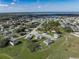 Aerial view of a residential neighborhood with well-maintained homes and green spaces near a lake at 429 Ohio Way, Kissimmee, FL 34759