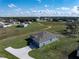 Aerial view of gray home showcases landscaping, driveway, and the surrounding neighborhood at 429 Ohio Way, Kissimmee, FL 34759