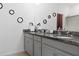 Bathroom with double sinks, granite countertop, and modern fixtures at 429 Ohio Way, Kissimmee, FL 34759