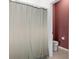 Neutral bathroom with privacy shower curtain, toilet, and neutral tile flooring at 429 Ohio Way, Kissimmee, FL 34759