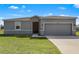 Attractive single-story home features a well-manicured lawn and a two-car garage with a concrete driveway at 429 Ohio Way, Kissimmee, FL 34759