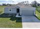 Attractive single-story home with a well-manicured lawn and a two-car garage with a concrete driveway at 429 Ohio Way, Kissimmee, FL 34759