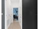 Hallway with neutral-toned walls, white doors, and view of the bedroom at 429 Ohio Way, Kissimmee, FL 34759